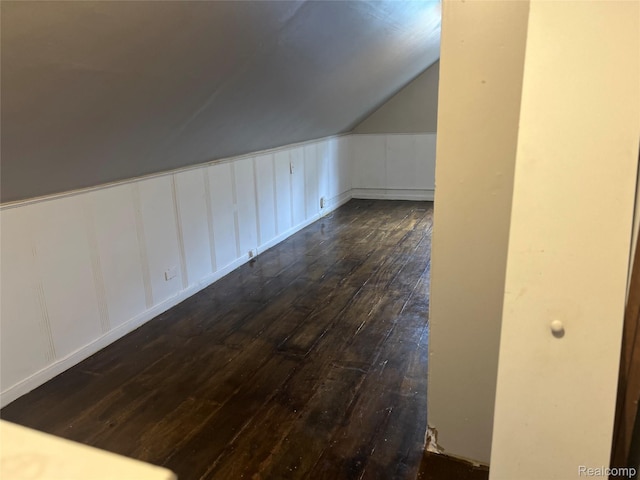 20294 Moenart St, Detroit, MI 48234 - additional living space featuring dark wood-style floors, a decorative wall, and vaulted ceiling