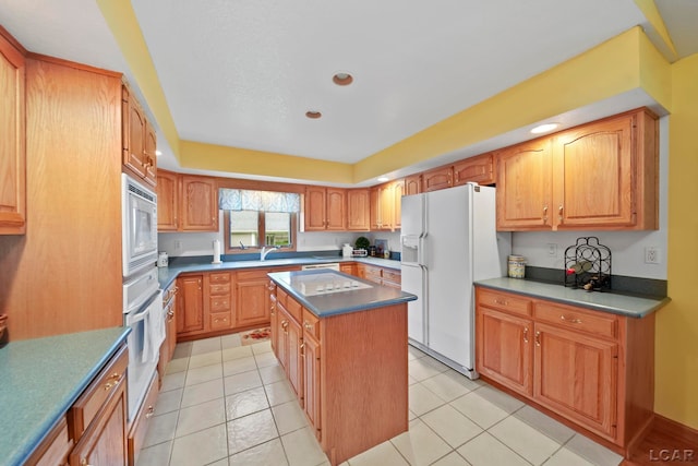 227 Lake View Dr, Hudson, MI 49247 - kitchen with white appliances, a center island, a sink, dark countertops, and recessed lighting