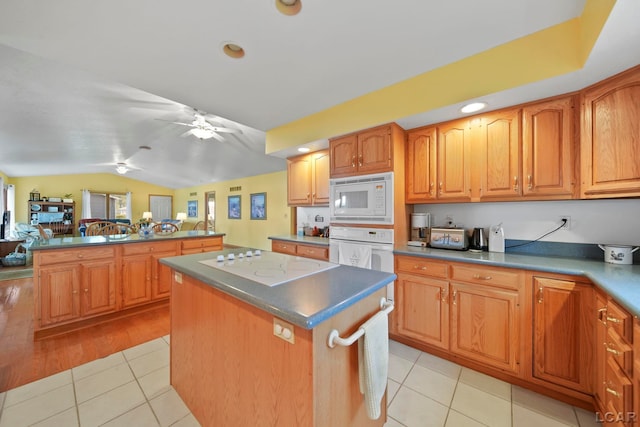227 Lake View Dr, Hudson, MI 49247 - kitchen featuring white appliances, a kitchen island, vaulted ceiling, a ceiling fan, and light tile patterned floors