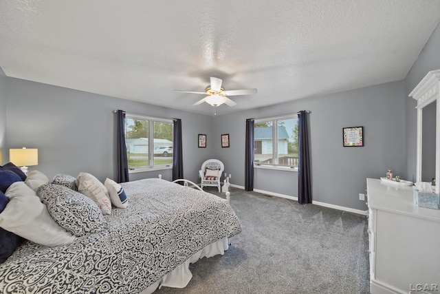 227 Lake View Dr, Hudson, MI 49247 - bedroom featuring multiple windows, carpet, baseboards, a ceiling fan, and a textured ceiling