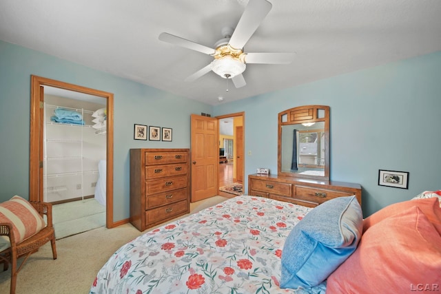 227 Lake View Dr, Hudson, MI 49247 - bedroom featuring light colored carpet, a closet, ceiling fan, a walk in closet, and baseboards