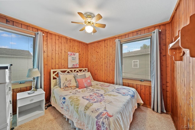 227 Lake View Dr, Hudson, MI 49247 - bedroom with wood walls, light colored carpet, and a ceiling fan