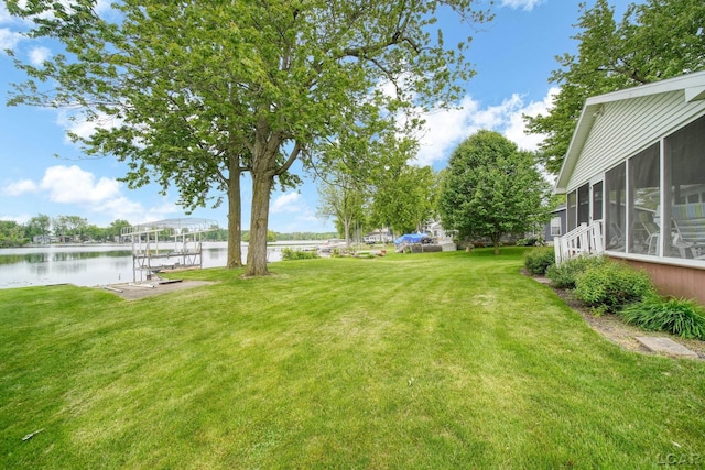 227 Lake View Dr, Hudson, MI 49247 - view of green lawn featuring a water view, a sunroom, boat lift, and a boat dock
