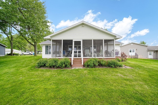227 Lake View Dr, Hudson, MI 49247 - rear view of property featuring a sunroom and a lawn