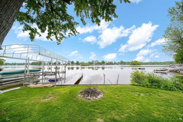 227 Lake View Dr, Hudson, MI 49247 - dock area with boat lift, a water view, and a lawn