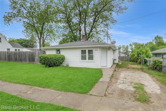 2089 Kenneth St, Burton, MI 48529 - view of front of property featuring a chimney and driveway