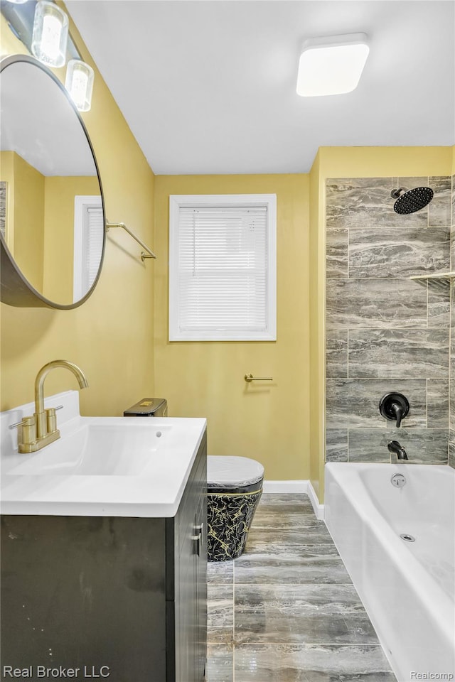 2089 Kenneth St, Burton, MI 48529 - full bath with vanity, baseboards,  shower combination, toilet, and wood finished floors
