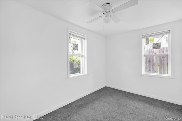 2089 Kenneth St, Burton, MI 48529 - empty room with dark colored carpet, baseboards, and ceiling fan