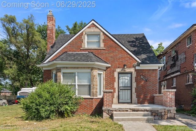 4220 Webb St, Detroit, MI 48204 - view of front of home featuring a shingled roof, a chimney, and brick siding