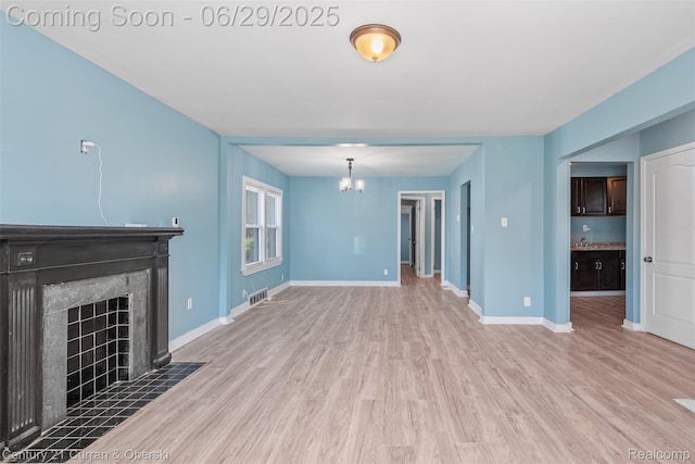 4220 Webb St, Detroit, MI 48204 - unfurnished living room featuring a chandelier, wood finished floors, and a fireplace