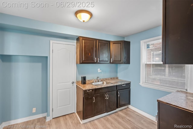 4220 Webb St, Detroit, MI 48204 - kitchen with light wood finished floors, light countertops, and dark brown cabinetry