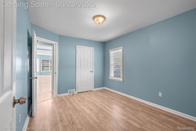 4220 Webb St, Detroit, MI 48204 - unfurnished bedroom featuring wood finished floors, multiple windows, and a closet