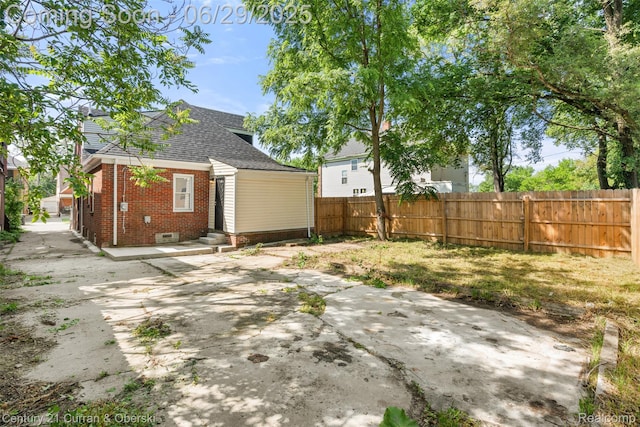 4220 Webb St, Detroit, MI 48204 - back of house featuring brick siding, entry steps, roof with shingles, a patio area, and crawl space
