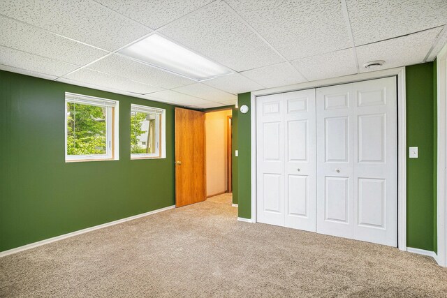 298 Chasseral Ct NW, Comstock Park, MI 49321 - unfurnished bedroom with carpet, a drop ceiling, a closet, and baseboards