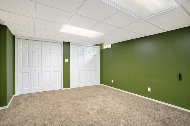 298 Chasseral Ct NW, Comstock Park, MI 49321 - unfurnished bedroom with two closets, carpet floors, a paneled ceiling, and baseboards