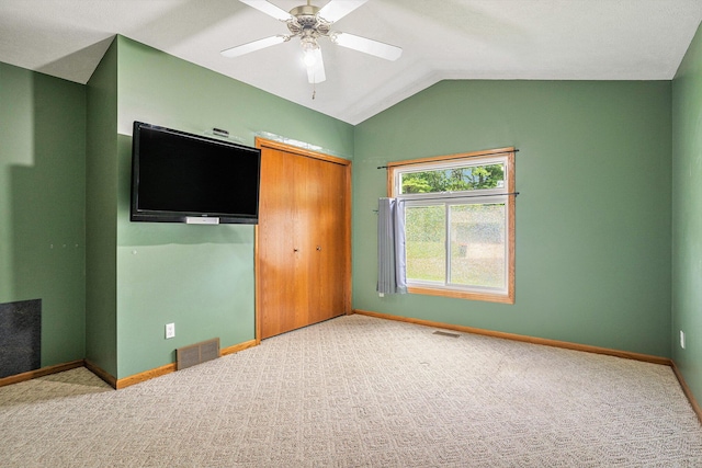 298 Chasseral Ct NW, Comstock Park, MI 49321 - unfurnished bedroom featuring a closet, carpet floors, lofted ceiling, baseboards, and a ceiling fan