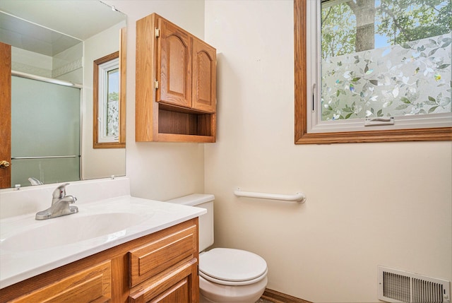 298 Chasseral Ct NW, Comstock Park, MI 49321 - full bath featuring toilet, vanity, and a shower with door