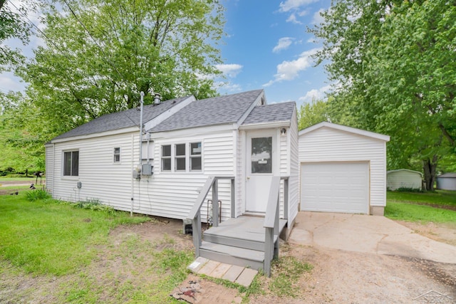 400 Mill St, Coleman, MI 48618 - view of front facade with concrete driveway, an outbuilding, a shingled roof, an attached garage, and a front lawn