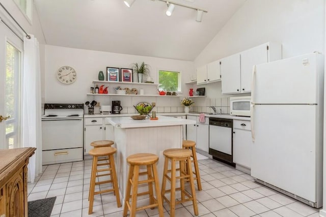 15826 Lakeshore Rd Unit 1, Union Pier, MI 49129 - kitchen with white appliances, open shelves, rail lighting, light countertops, and white cabinets