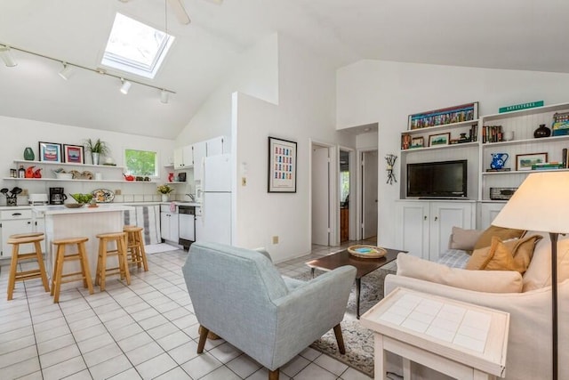 15826 Lakeshore Rd Unit 1, Union Pier, MI 49129 - living room featuring track lighting, a skylight, high vaulted ceiling, and light tile patterned flooring