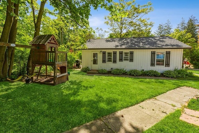 15826 Lakeshore Rd Unit 1, Union Pier, MI 49129 - view of front of home with a playground, a front yard, and board and batten siding