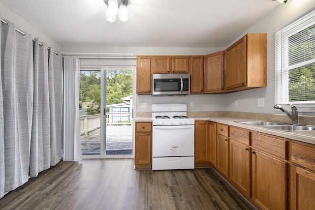 68149 Lawndale St, Edwardsburg, MI 49112 - kitchen featuring stainless steel microwave, white gas range, a sink, and healthy amount of natural light