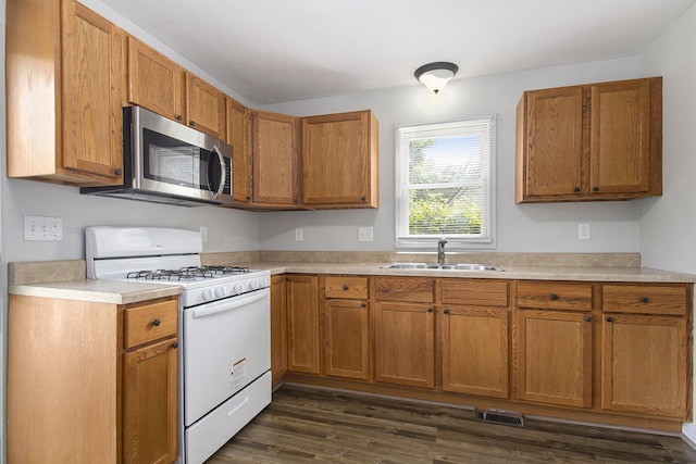 68149 Lawndale St, Edwardsburg, MI 49112 - kitchen featuring stainless steel microwave, white gas stove, a sink, and light countertops