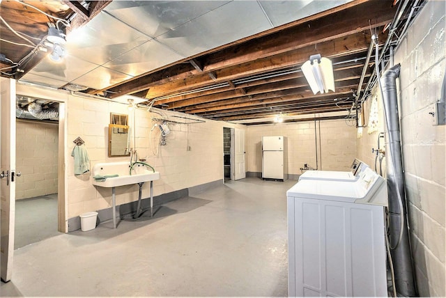 269 E 24th St, Holland, MI 49423 - unfinished below grade area featuring freestanding refrigerator and independent washer and dryer