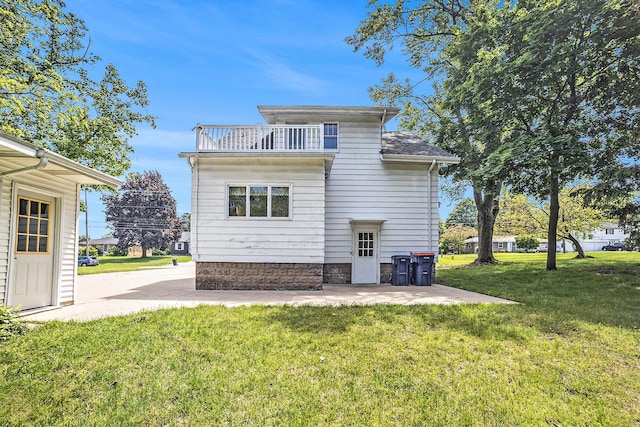269 E 24th St, Holland, MI 49423 - rear view of property with a balcony, a yard, and a patio area