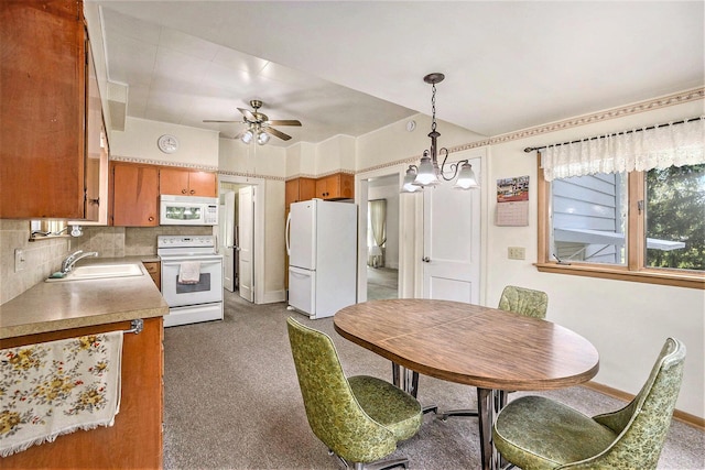 269 E 24th St, Holland, MI 49423 - kitchen with white appliances, a sink, carpet flooring, brown cabinets, and light countertops