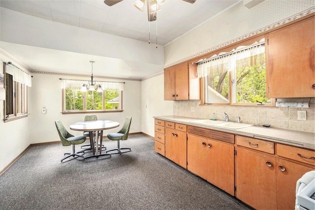 269 E 24th St, Holland, MI 49423 - kitchen with a sink, baseboards, light countertops, backsplash, and ornamental molding