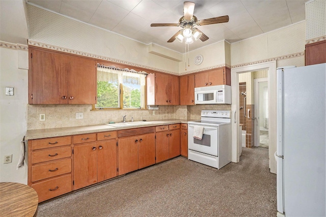 269 E 24th St, Holland, MI 49423 - kitchen with white appliances, a sink, ceiling fan, light countertops, and crown molding