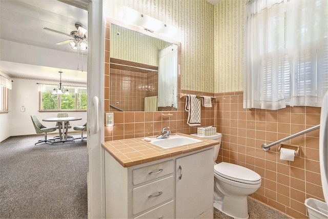 269 E 24th St, Holland, MI 49423 - bathroom with wallpapered walls, vanity, a wainscoted wall, toilet, and a ceiling fan