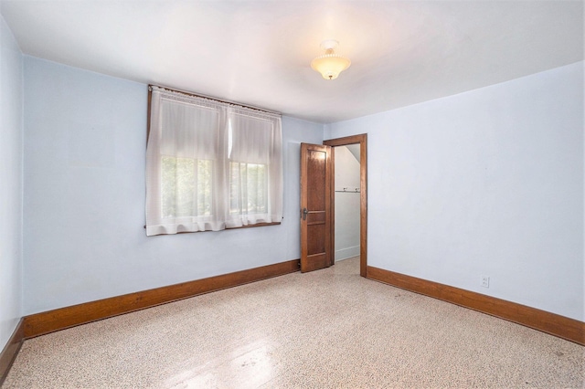 269 E 24th St, Holland, MI 49423 - unfurnished room with baseboards and speckled floor