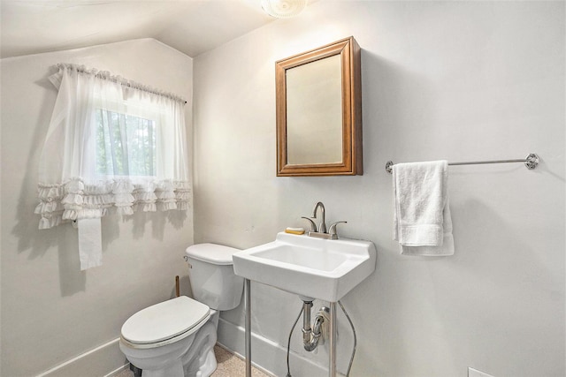 269 E 24th St, Holland, MI 49423 - half bathroom with toilet, lofted ceiling, and baseboards