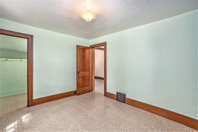 269 E 24th St, Holland, MI 49423 - unfurnished bedroom with baseboards, speckle patterned floor, and a closet