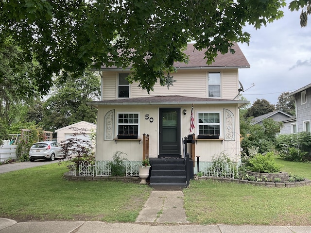 50 N Sprague St, Coldwater, MI 49036 - view of front of property featuring a front lawn and a garage