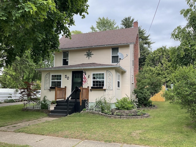 50 N Sprague St, Coldwater, MI 49036 - view of front facade with a chimney and a shingled roof