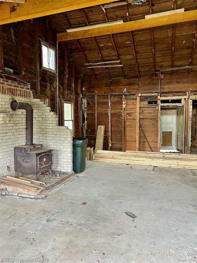 2935 Jackson Blvd, Highland, MI 48356 - miscellaneous room featuring lofted ceiling and a wood stove