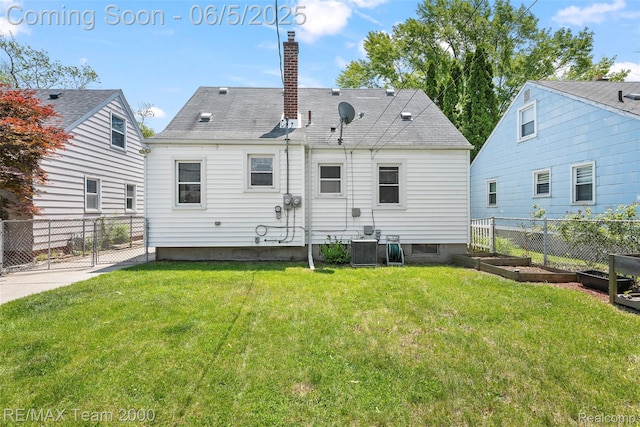 2922 Bailey Ave, Wyandotte, MI 48146 - back of property featuring a chimney, cooling unit, and a garden