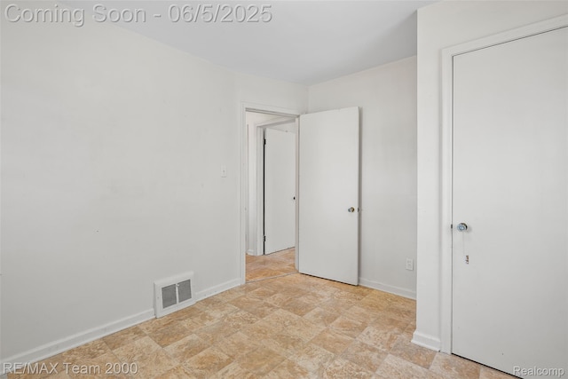 2922 Bailey Ave, Wyandotte, MI 48146 - unfurnished bedroom featuring baseboards and stone finish flooring