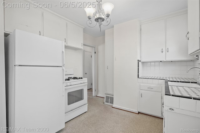 2922 Bailey Ave, Wyandotte, MI 48146 - kitchen with white appliances, tile countertops, white cabinets, decorative backsplash, and a chandelier