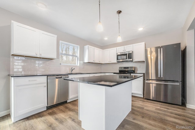 6270 Tommy Trl, Mount Morris, MI 48458 - kitchen featuring stainless steel appliances, a sink, dark countertops, white cabinets, and wood finished floors