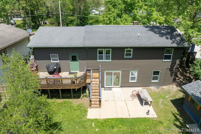 510 W Marshall St, Hastings, MI 49058 - rear view of house with a deck, a chimney, a patio area, and a lawn
