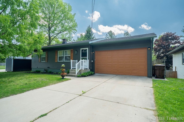 510 W Marshall St, Hastings, MI 49058 - view of front of house with a front lawn, an attached garage, a storage shed, and driveway