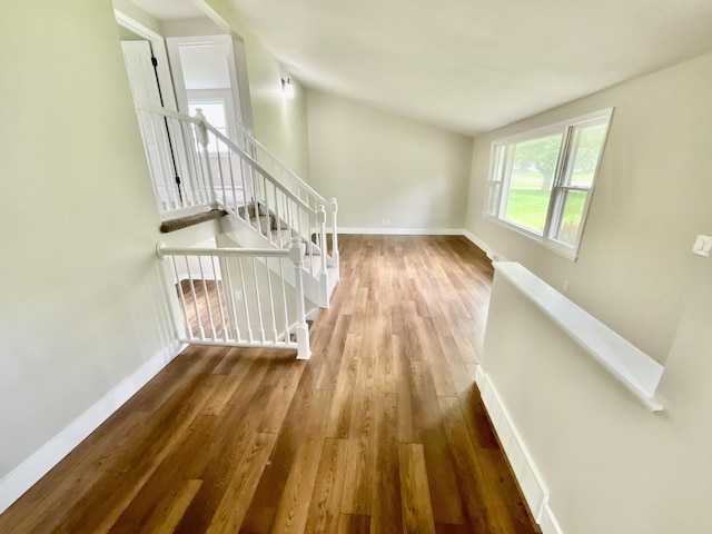 4408 Arbor Dr, Okemos, MI 48864 - corridor featuring an upstairs landing, wood finished floors, baseboards, and lofted ceiling
