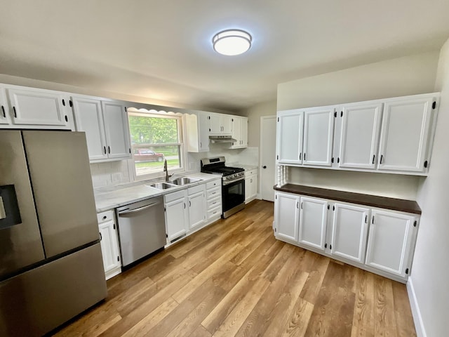 4408 Arbor Dr, Okemos, MI 48864 - kitchen with stainless steel appliances, a sink, light wood-style floors, and white cabinets