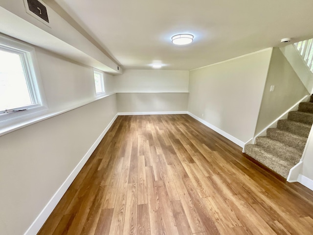 4408 Arbor Dr, Okemos, MI 48864 - below grade area featuring wood finished floors, baseboards, and stairway