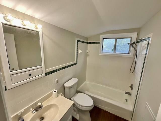 4408 Arbor Dr, Okemos, MI 48864 - full bathroom with tile walls, bathtub / shower combination, vaulted ceiling, wood finished floors, and toilet