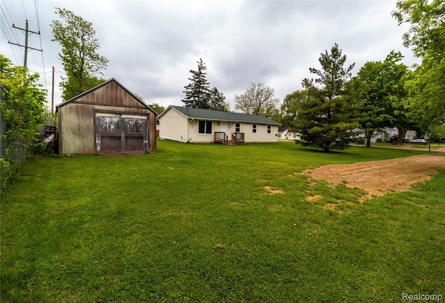 519 S Elm St, Lapeer, MI 48446 - view of grassy yard with an outbuilding